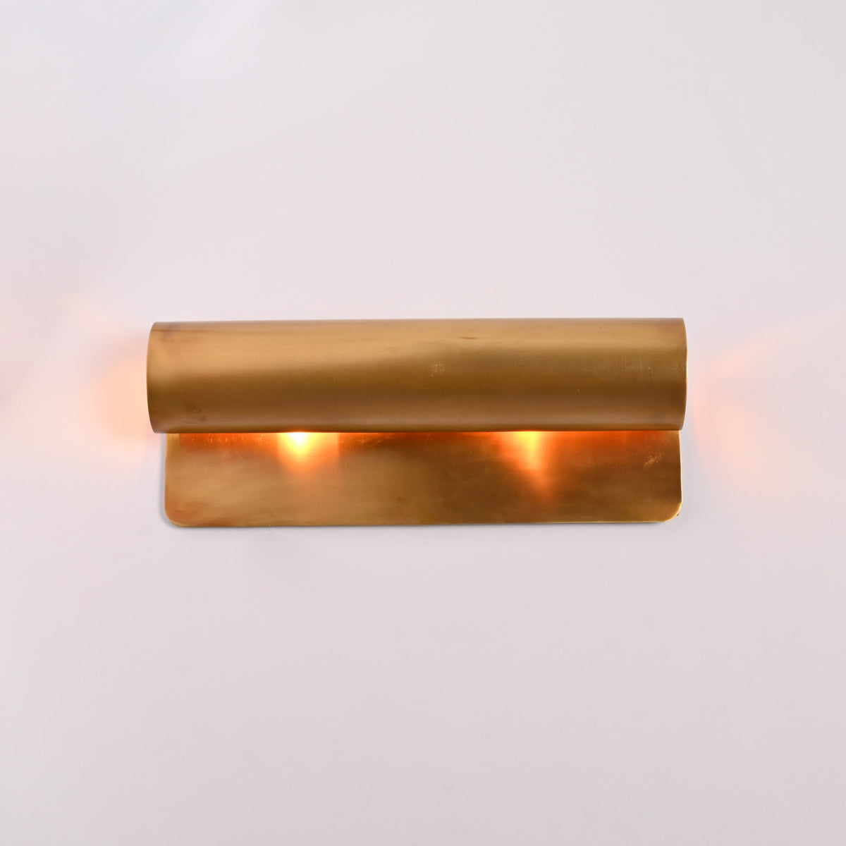 Customizable linear up down wall light with solid brass construction and warm ambient lighting effect