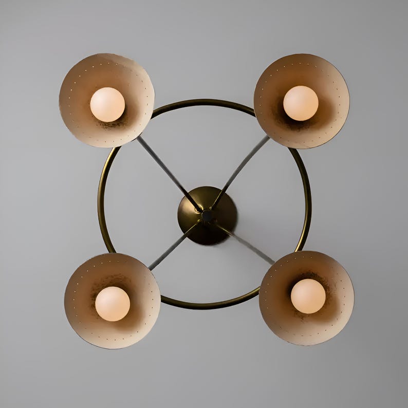 Bottom view of Diabolo brass chandelier highlighting symmetrical cone shade arrangement and soft glowing bulbs