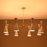 Side view of illuminated 16-light Diabolo chandelier featuring white metal cone shades and brass structure, warm ambient ceiling light.