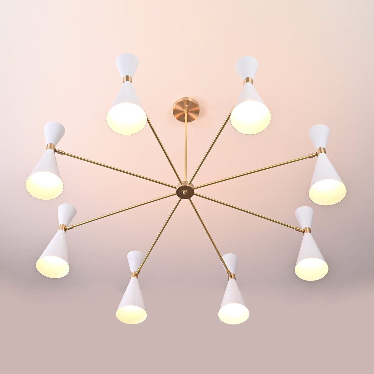 Top view of 16-light Diabolo chandelier showing radial brass arms and white cone shades, modern mid-century brass ceiling light.