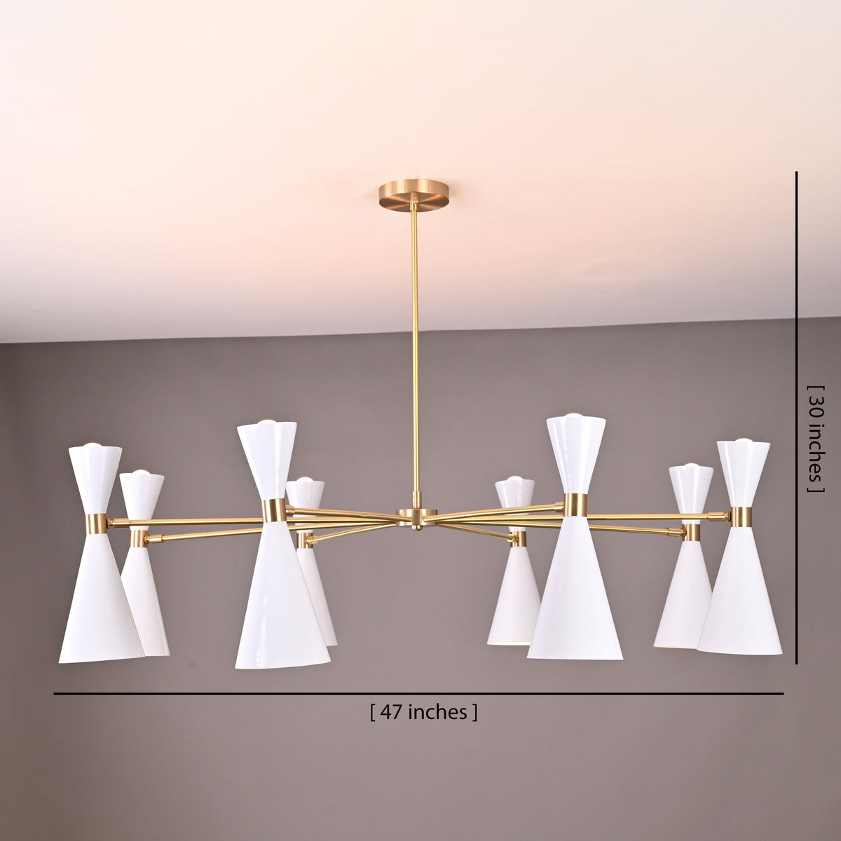 Diabolo chandelier 16-light with 47-inch width and 30-inch height dimensions marked, brushed brass with white cone shades.