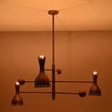 Artistic angle of Diabolo designer brass chandelier highlighting geometric balance, premium craftsmanship, and atmospheric lighting.