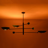 Disc chandelier creating soft indirect light patterns across the ceiling in a warm interior