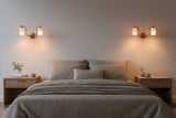 Dual alabaster cylinder wall light with curved brass arms and round brass patina canopy for elegant interiors