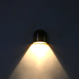 Closeup of dual tone brass wall sconce showing dark aged upper patina and warmer brass lower section