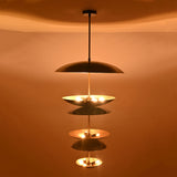 Close-up illuminated view of Eclipse Cascade Chandelier showcasing sculptural multi-tier dish shades