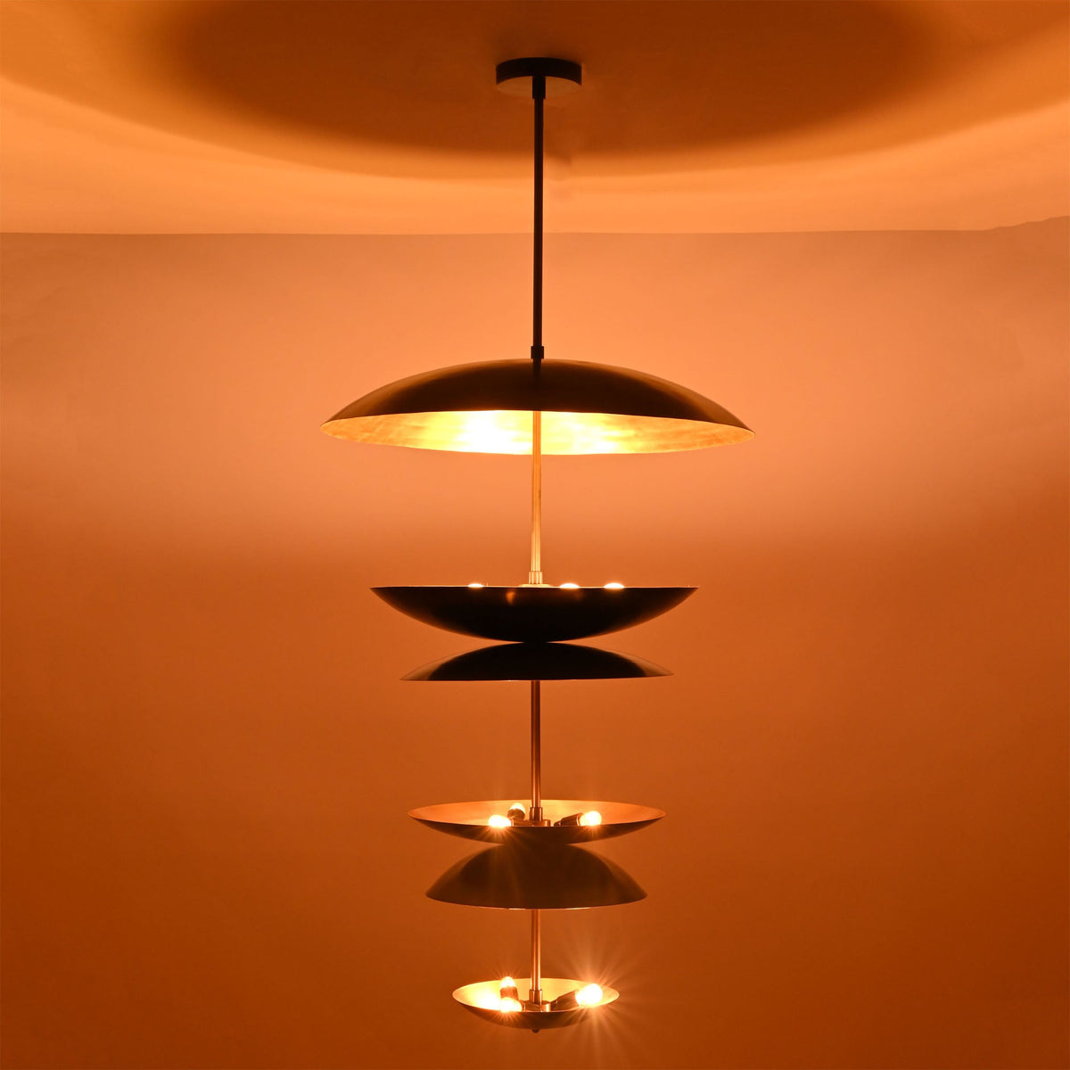 Full view of illuminated Eclipse Cascade Chandelier creating elegant layered ambient illumination