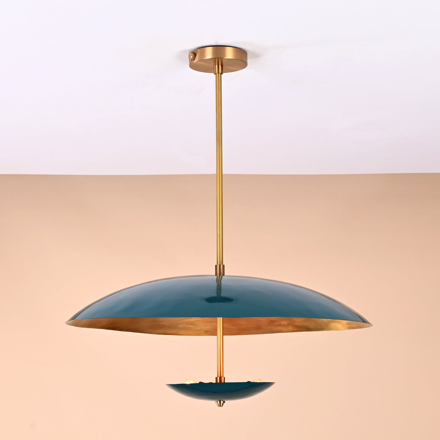 Front view of handcrafted emerald green brass chandelier with golden interior finish and elegant dual-bowl silhouette