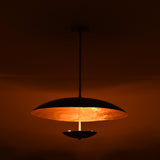 Modern emerald green brass ceiling lamp glowing warmly with golden interior reflection and minimalist shape