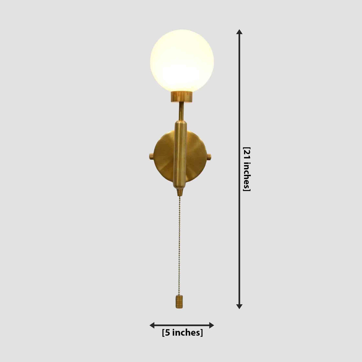 Raw brass pull-chain globe wall sconce, illuminated with a round frosted globe; dimension view shows 21-inch height and 5-inch width.