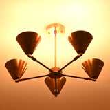 Five-light brass cone chandelier viewed from below, showcasing soft ambient illumination and industrial elegance.