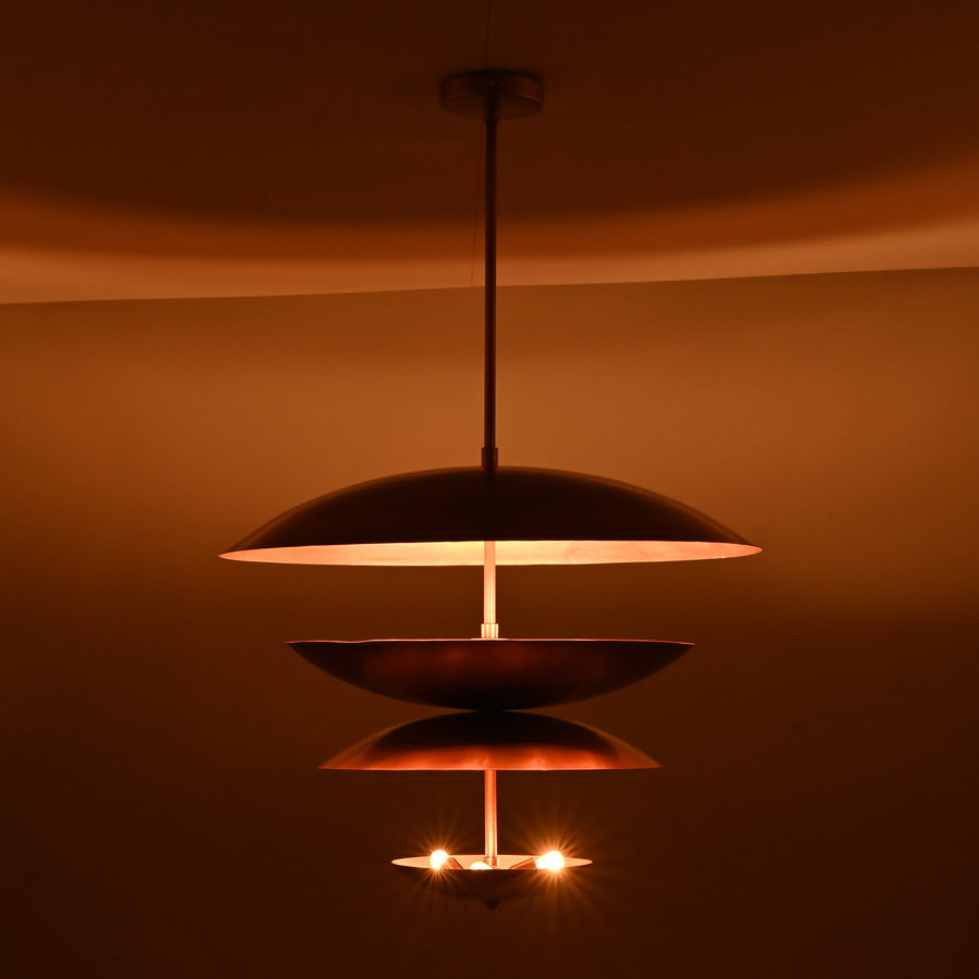 Studio photograph of a copper-finish multi-tier bowl-shaped chandelier with indirect uplighting, crafted in solid brass by Brass Leaf Studio.