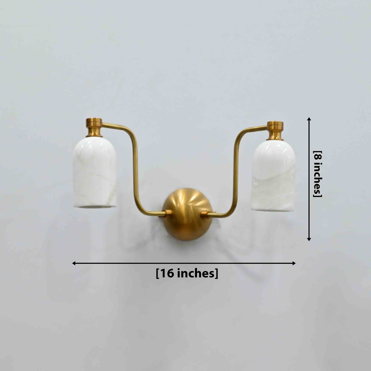 Florence dual alabaster shade brass wall sconce with brass patina arms and warm ambient glow