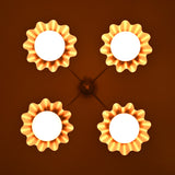 Four-light brass chandelier illuminated in low light, creating a warm ambient glow.