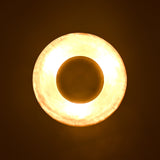 Top glowing view of brass disc ceiling light forming an elegant golden halo effect on ceiling