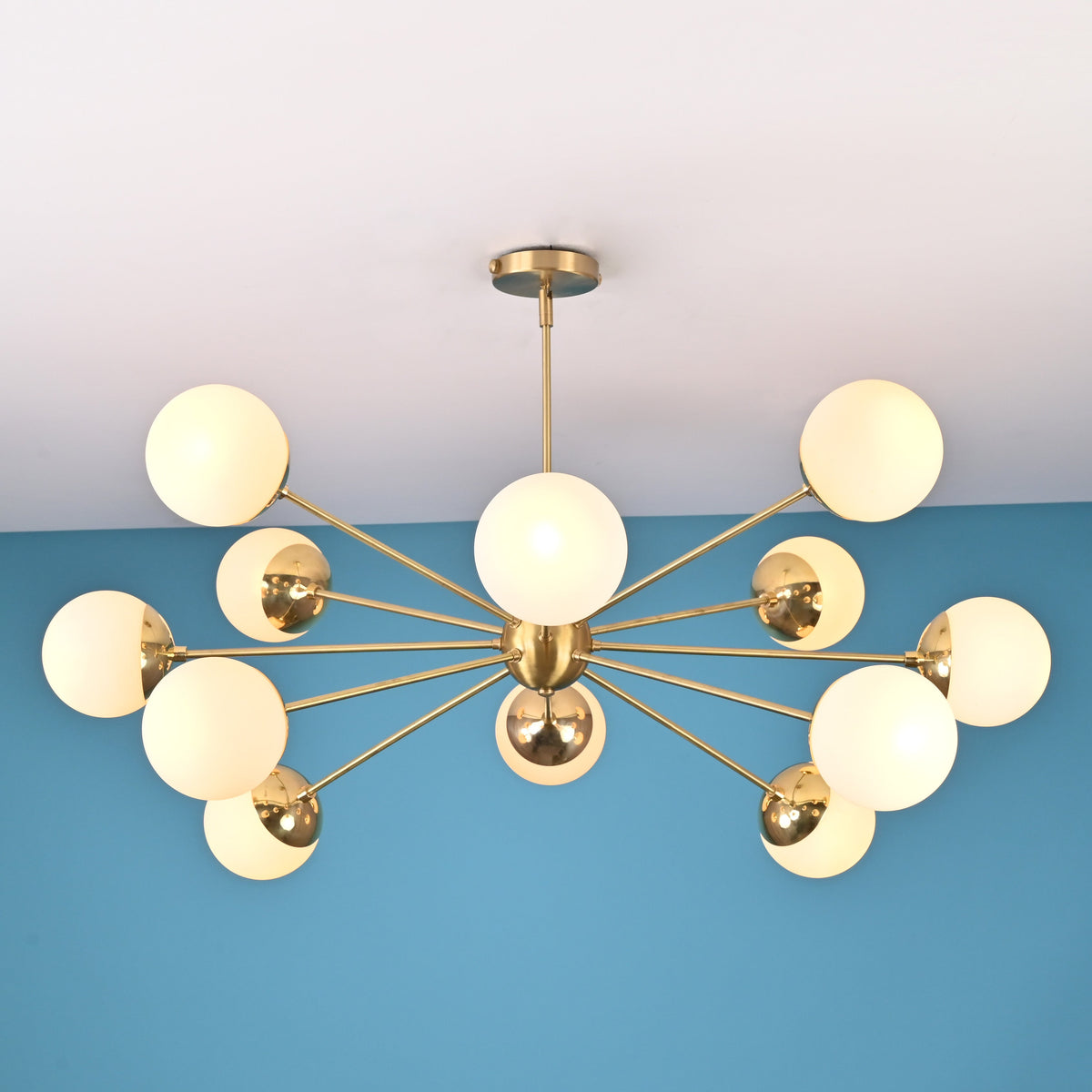 Handcrafted solid brass 12 light sputnik chandelier with opal globe shades and sculptural arms