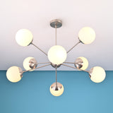 Handcrafted solid brass 8 light sputnik chandelier with opal globe shades and sculptural arms
