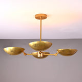 Front angle view of handcrafted solid brass chandelier with four hammered bowl shades and central brass rod suspension.