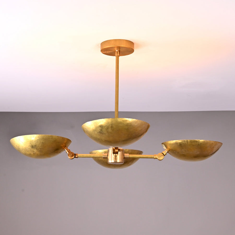 Front angle view of handcrafted solid brass chandelier with four hammered bowl shades and central brass rod suspension.