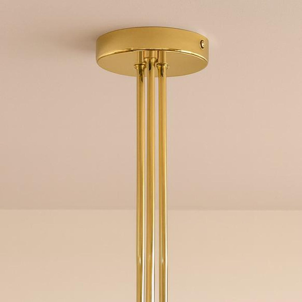 Handcrafted brass ceiling canopy and rod detail of a mid-century modern bowl glass chandelier