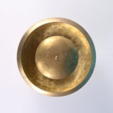 Close-up detail of brushed brass ceiling light showing handcrafted texture, lacquer-coated finish, and natural patina variations.