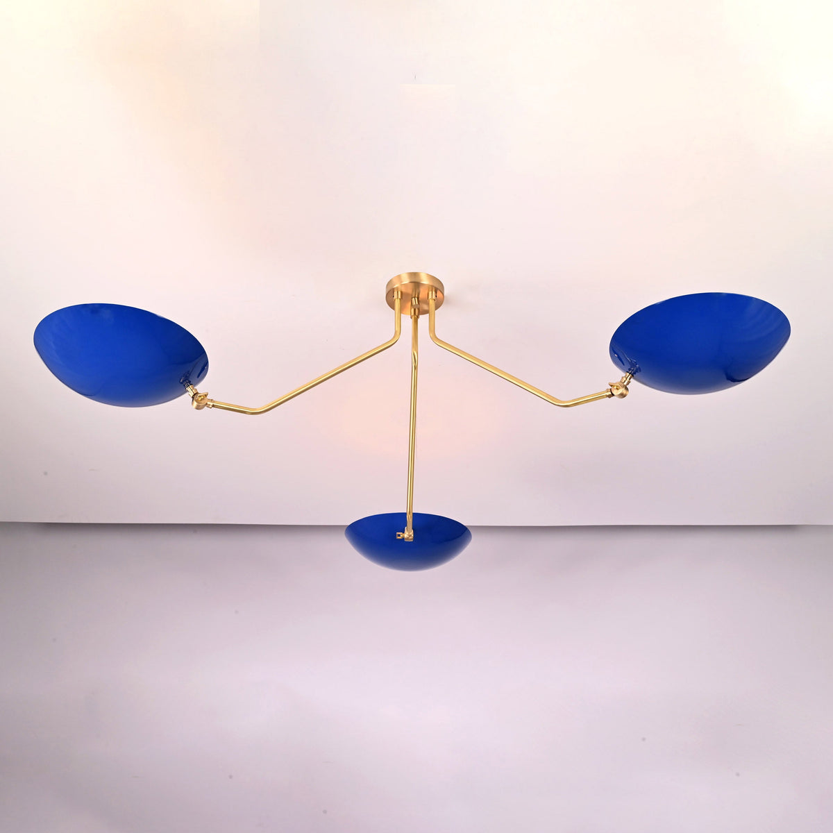 Handcrafted solid brass flush mount ceiling light with sculpted arms and blue bowl shades