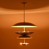Handmade layered brass pendant with 8-light arrangement casting golden radiance