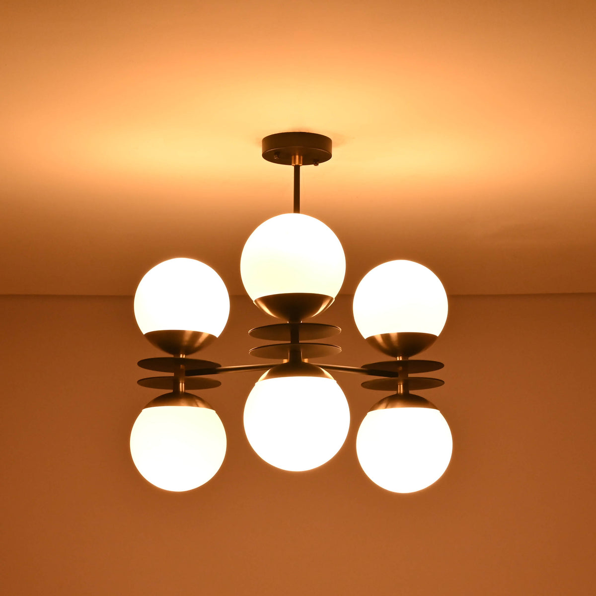 Handmade brass chandelier with six opal glass globes showcasing premium finish and warm lighting