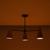 Close-up of handcrafted copper cone shade showing smooth finish and warm interior glow