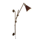 Adjustable industrial brass wall sconce with light on, showcasing warm illumination