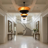 Large 42 inch disc chandelier installed in a modern living room with dramatic stacked saucer design and warm glow