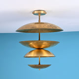 Layered brass disc flush mount ceiling light with sculpted bowl shades, handcrafted in solid brass with warm indirect ambient lighting.