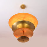 Bottom view of layered brass disc chandelier showing radiant hand-polished reflective surfaces
