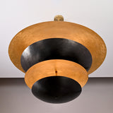 Bottom view of brass and black layered disc chandelier showcasing sculptural stepped bowls and warm reflective interiors.
