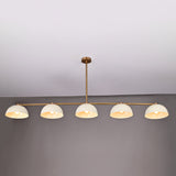 Full front view of 5-light linear brass chandelier with enamel dome shades and downrod ceiling mount in neutral interior