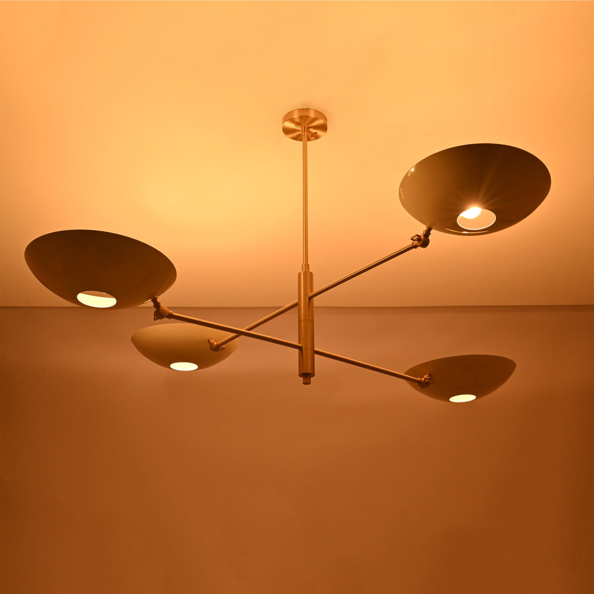 Linear saucer bowl chandelier with four curved shades and slim central stem for modern ceiling lighting