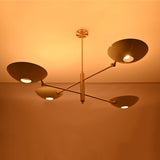 Linear saucer bowl chandelier with four curved shades and slim central stem for modern ceiling lighting