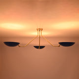 Low profile three-light brass flush mount ceiling fixture ideal for modern interiors