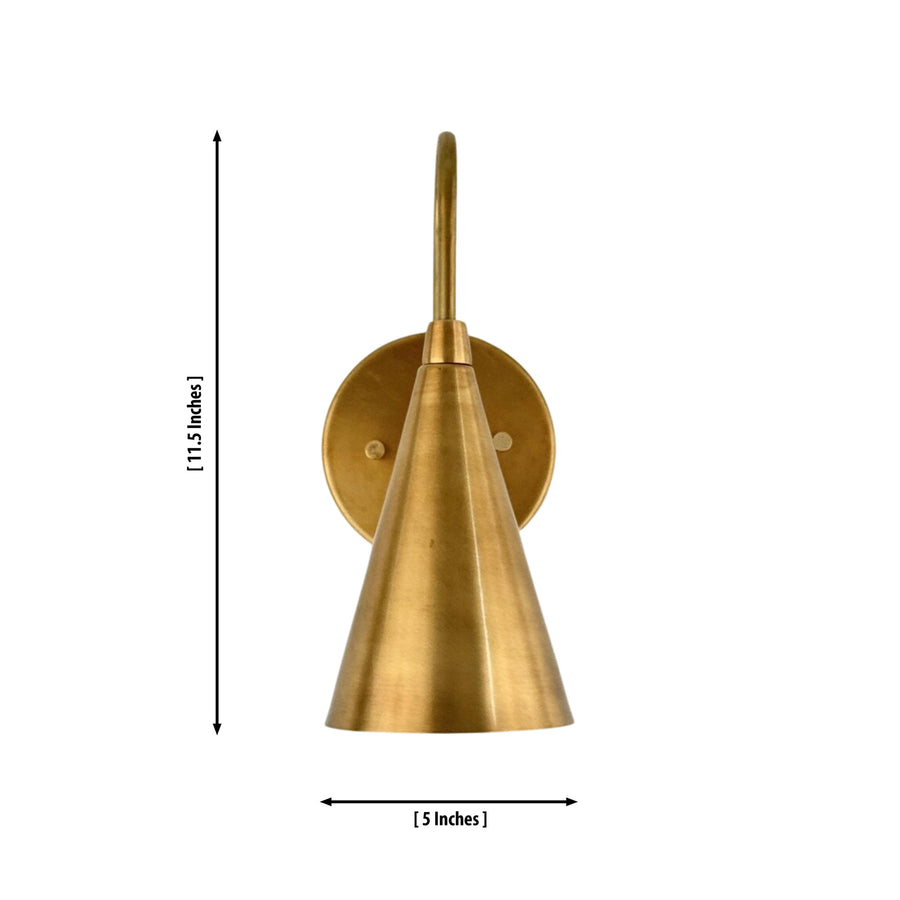 Luna Tapered Cone Wall Sconce Model 32705 installed in a modern living room, providing warm ambient lighting with a handcrafted solid brass finish.