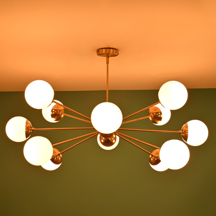 Modern 12 light brass globe chandelier with opal glass shades and symmetrical mid century design