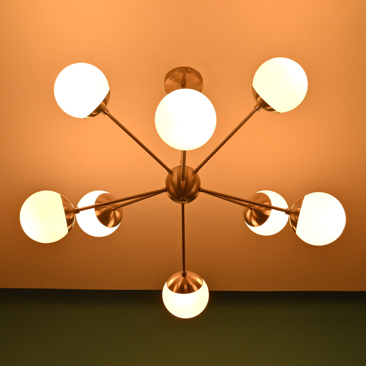 Luxury 8 light brass chandelier with opal globes providing warm ambient illumination for refined interiors