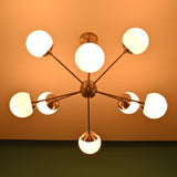 Luxury 8 light brass chandelier with opal globes providing warm ambient illumination for refined interiors