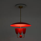 Three light red dome chandelier in full brass construction with enamel painted shades and decorative center ball
