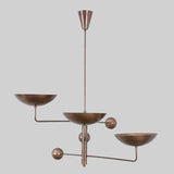 Modern handcrafted brass chandelier featuring three bowl-shaped shades and geometric balance-arm design