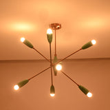 Mid century style sputnik chandelier in mint green finish with brass structure and warm glowing bulbs.