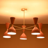 Mid-century modern peach and brass chandelier glowing warmly in ambient lighting