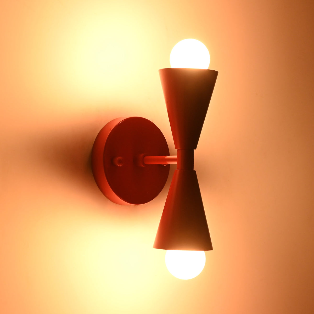 Side perspective of illuminated Milan Modern Double Cone Wall Sconce with dual directional lighting
