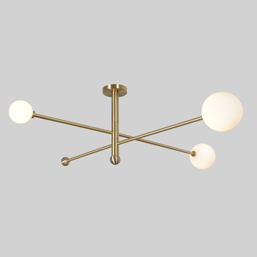 Modern 3-light brushed brass globe ceiling light with opal glass shades by Brass Leaf Studio.