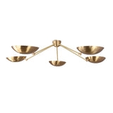 Minimalist brass ceiling chandelier with bowl shades creating soft indirect uplighting.
