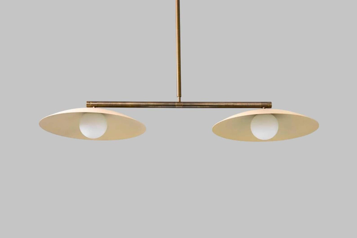Bottom view of minimalist brass disc chandelier showcasing dual glass globe lighting design